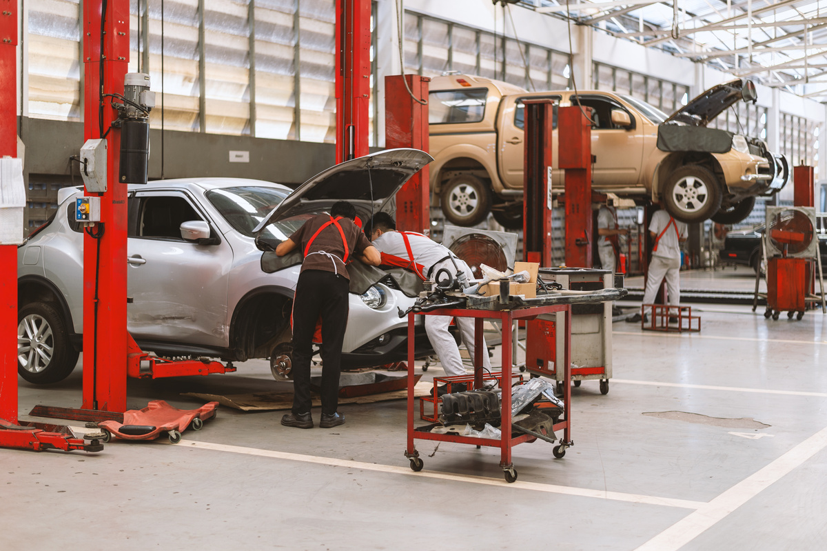 garagistes réparant une voiture dans un garage